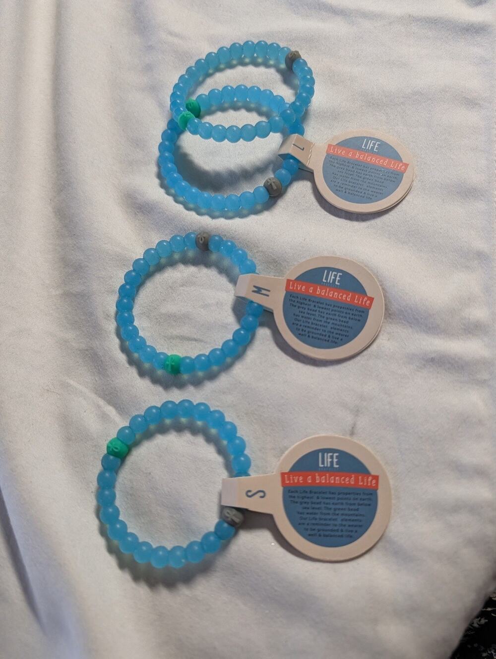 Lot Of 4"Live A Balanced Life" Silicone/Plastic Bracelet Size S, M, L & ?